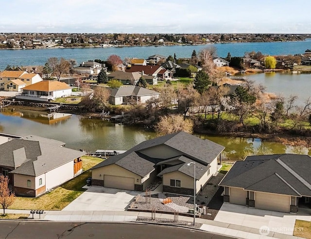 bird's eye view with a water view and a residential view