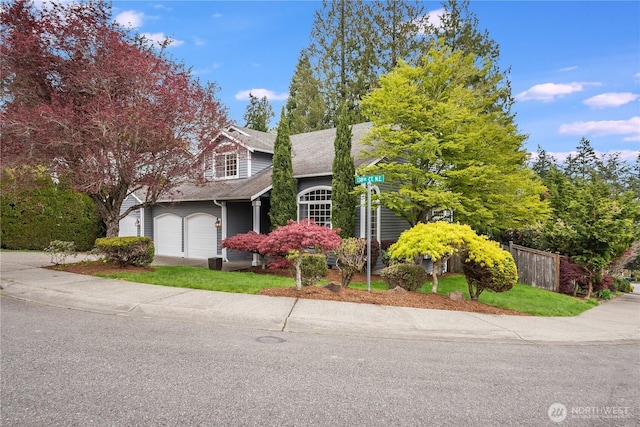 9300 138th Ct NE, Redmond, WA 98052 - view of front of house with a garage, fence, and driveway