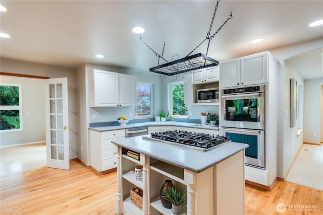 9300 138th Ct NE, Redmond, WA 98052 - kitchen with appliances with stainless steel finishes, a sink, light countertops, light wood finished floors, and recessed lighting