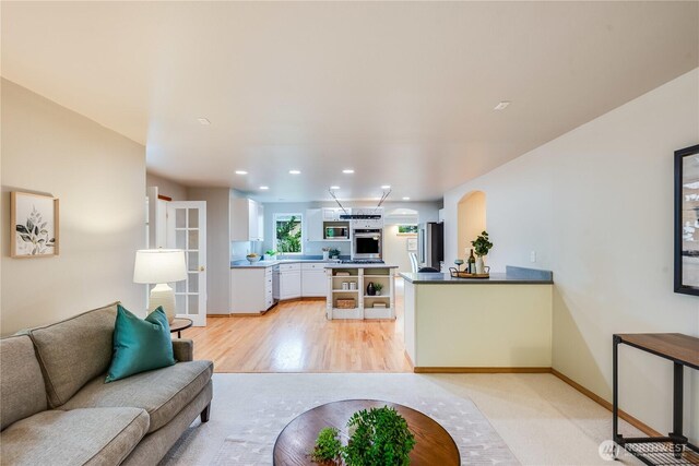 9300 138th Ct NE, Redmond, WA 98052 - living area with light wood-style floors, recessed lighting, baseboards, and arched walkways