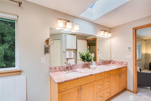 9300 138th Ct NE, Redmond, WA 98052 - bathroom with a sink, tile patterned floors, a skylight, and double vanity