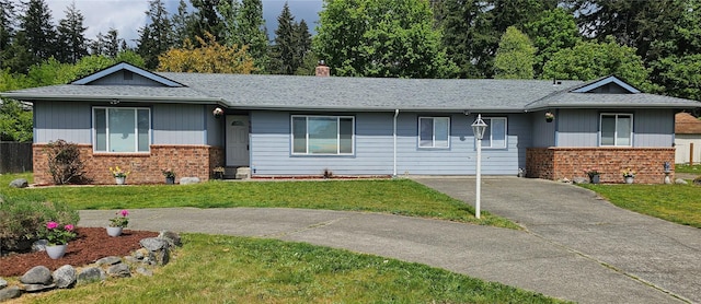 9601 128th Ave NW, Gig Harbor, WA 98329 - ranch-style home featuring brick siding, a front lawn, a chimney, and roof with shingles