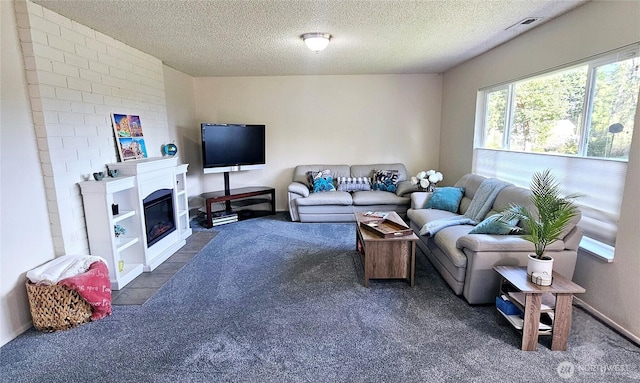 9601 128th Ave NW, Gig Harbor, WA 98329 - living room with dark carpet, a textured ceiling, and a glass covered fireplace