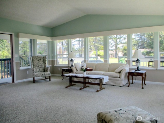 carpeted living room with plenty of natural light, baseboards, and vaulted ceiling
