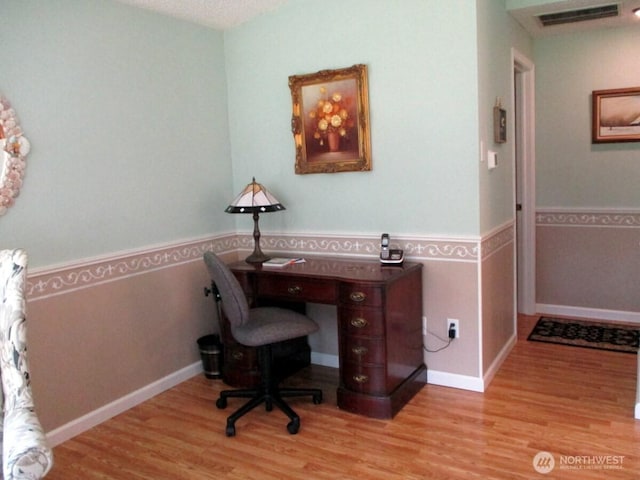 office with visible vents and wood finished floors