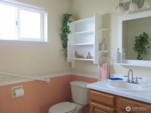 half bathroom with toilet and vanity