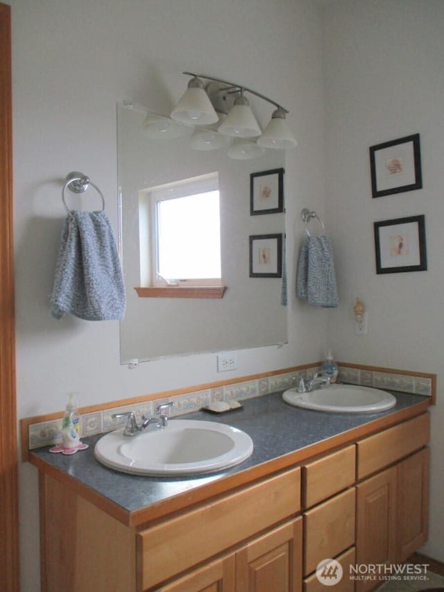bathroom featuring a sink and double vanity