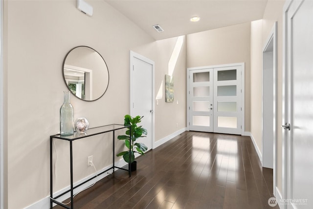 entrance foyer featuring baseboards, visible vents, french doors, and wood finished floors