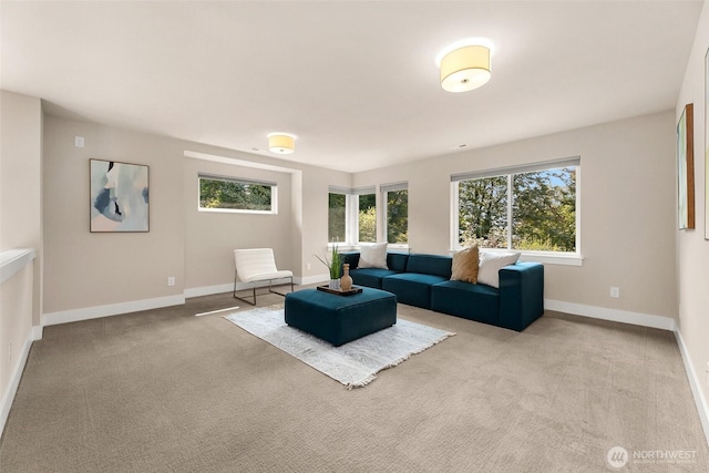 carpeted living area featuring baseboards