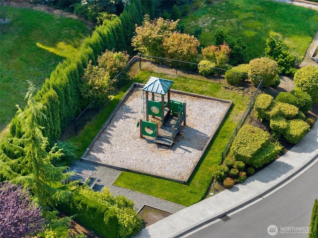 view of home's community featuring fence and playground community