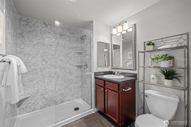 700 Front St S Unit B301, Issaquah, WA 98027 - full bathroom featuring toilet, tiled shower, vanity, and tile patterned flooring