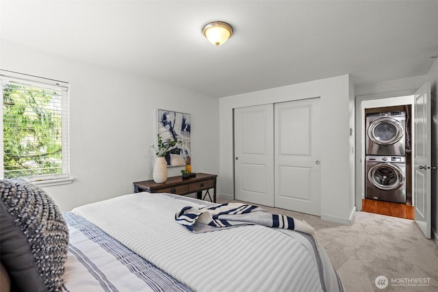 700 Front St S Unit B301, Issaquah, WA 98027 - bedroom with stacked washer / dryer, a closet, carpet, and baseboards