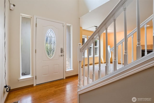 foyer entrance featuring stairs and wood finished floors
