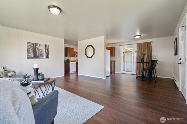 1209 Sherman Ave, Port Orchard, WA 98366 - living room featuring a baseboard heating unit, dark wood-style flooring, and baseboards