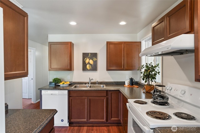 1209 Sherman Ave, Port Orchard, WA 98366 - kitchen with white appliances, under cabinet range hood, a sink, dark countertops, and dark wood-style flooring
