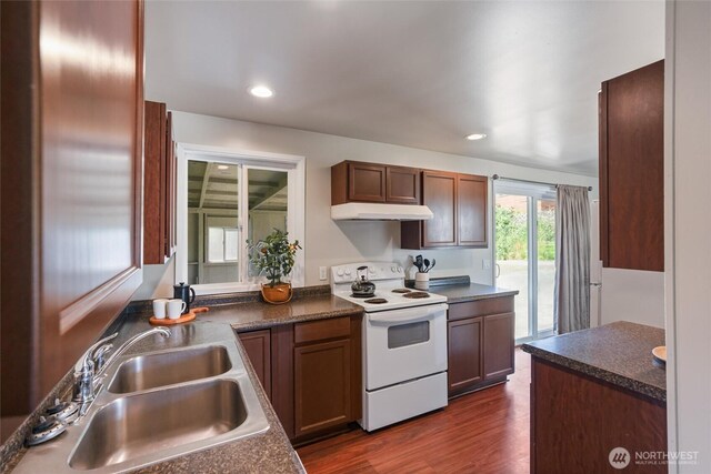 1209 Sherman Ave, Port Orchard, WA 98366 - kitchen with electric stove, a sink, under cabinet range hood, dark countertops, and dark wood-type flooring