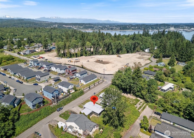 1209 Sherman Ave, Port Orchard, WA 98366 - aerial view of property and surrounding area featuring a water and mountain view, a heavily wooded area, and nearby suburban area