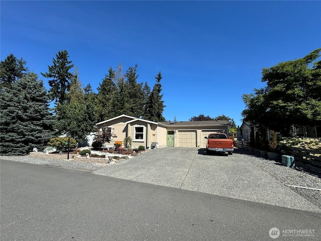 view of front of house featuring aphalt driveway and a garage