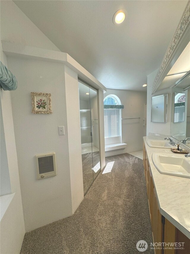 bathroom with double vanity, a sink, and recessed lighting