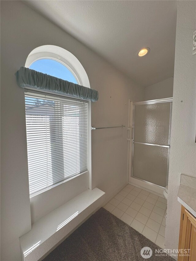 full bathroom featuring tile patterned flooring, vanity, recessed lighting, and a shower stall