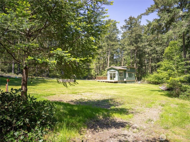 25 Eliza Ln, Lopez Island, WA 98261 - view of yard featuring a wooden deck and a forest view