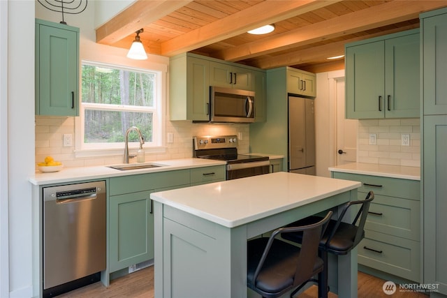 25 Eliza Ln, Lopez Island, WA 98261 - kitchen featuring green cabinets, a sink, stainless steel appliances, and beam ceiling