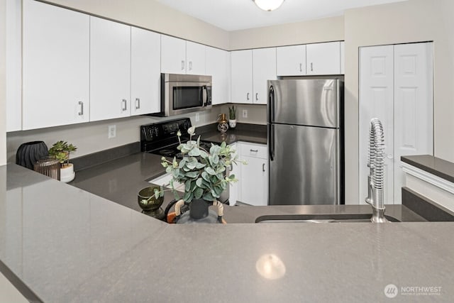 15300 112th Ave NE Unit C102, Bothell, WA 98011 - kitchen with appliances with stainless steel finishes, white cabinetry, and dark countertops