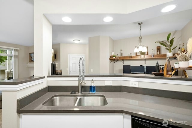 15300 112th Ave NE Unit C102, Bothell, WA 98011 - kitchen with dark countertops, recessed lighting, white cabinets, and hanging light fixtures