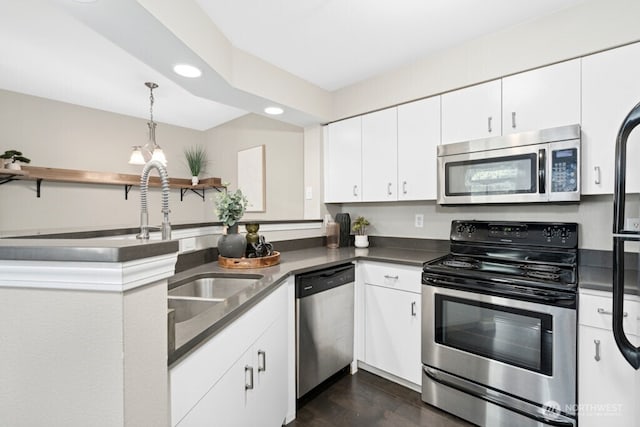 15300 112th Ave NE Unit C102, Bothell, WA 98011 - kitchen featuring appliances with stainless steel finishes, dark countertops, recessed lighting, a peninsula, and white cabinetry