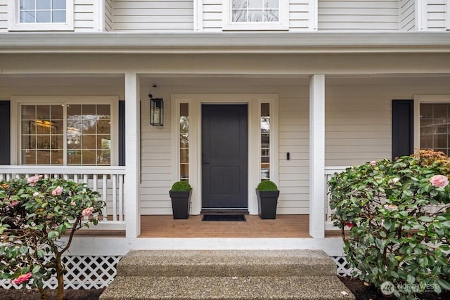 view of exterior entry with a porch