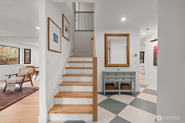 stairway with tile patterned floors and recessed lighting