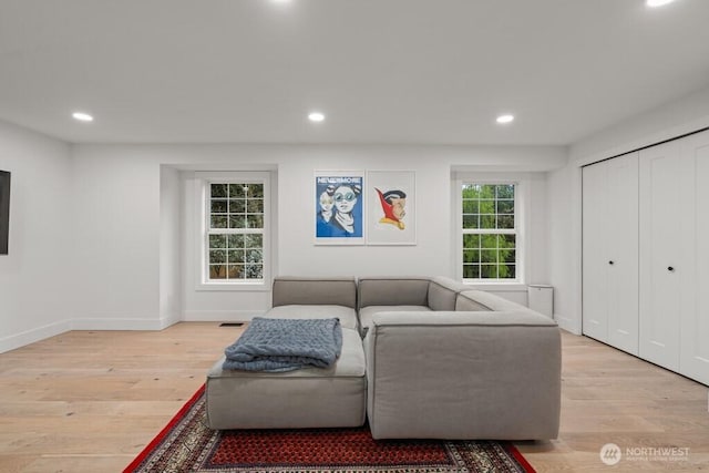 living room featuring light wood-style flooring and recessed lighting