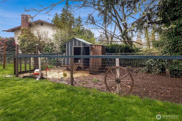 view of yard with fence and an outbuilding