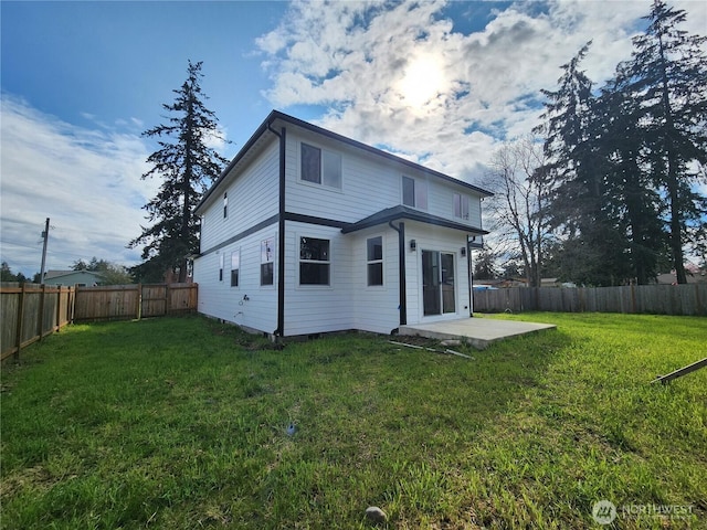back of property featuring a lawn, a fenced backyard, and a patio