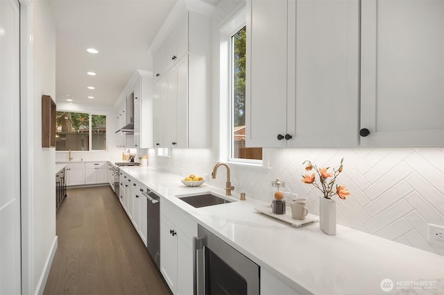 kitchen featuring white cabinetry, a sink, and beverage cooler