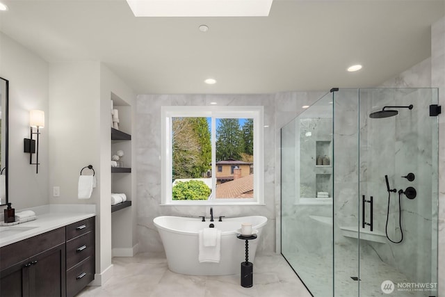 full bath featuring a freestanding bath, recessed lighting, built in features, and a shower stall