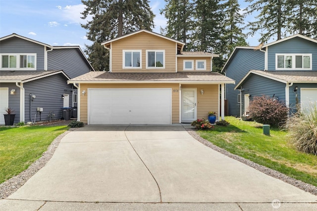 traditional-style home with a garage, driveway, a front yard, and a shingled roof