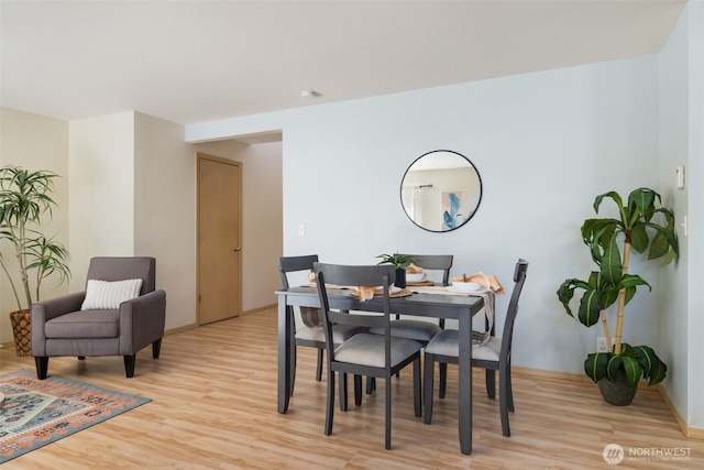 dining space featuring light wood-style flooring