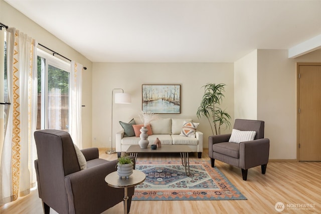 living area with wood finished floors and baseboards