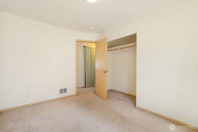 unfurnished bedroom with carpet, baseboards, and a closet