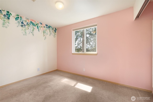 empty room featuring carpet flooring and baseboards