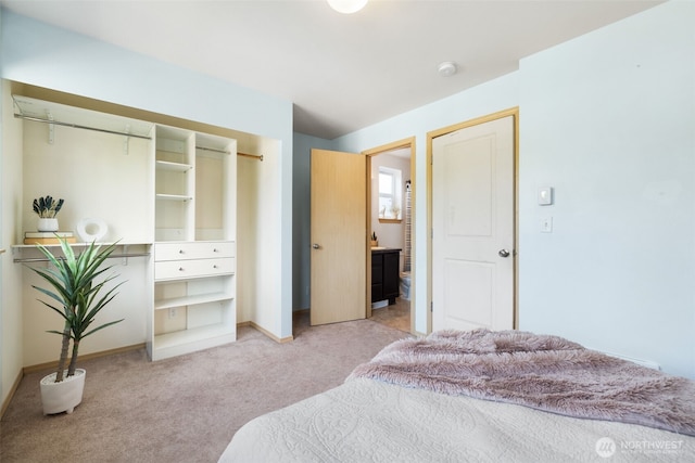 bedroom featuring light colored carpet and baseboards