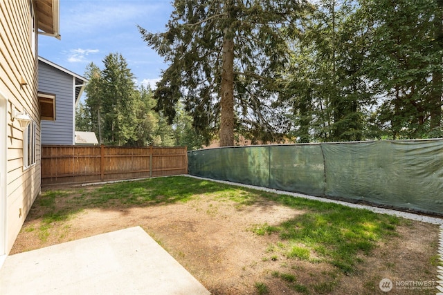 fenced backyard with a patio area