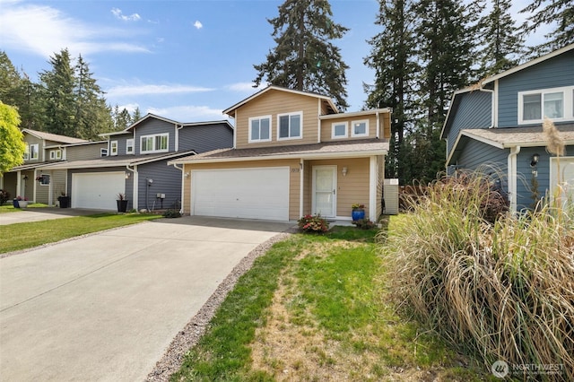 traditional-style home featuring concrete driveway, a garage, and a front lawn