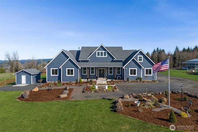 craftsman-style house with a front lawn and an outdoor structure