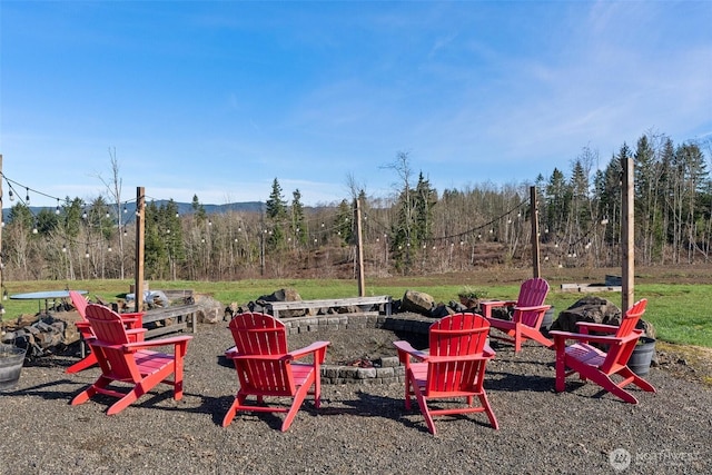 view of yard featuring an outdoor fire pit and a patio area