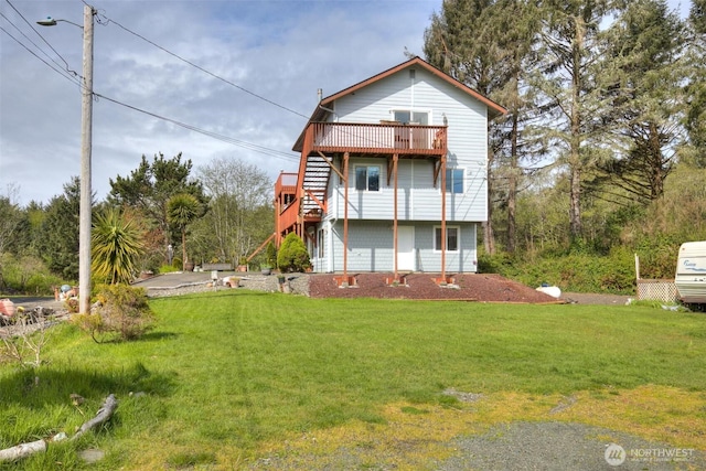 2691 State Route 109, Ocean City, WA 98569 - back of property with a lawn, stairs, and a deck