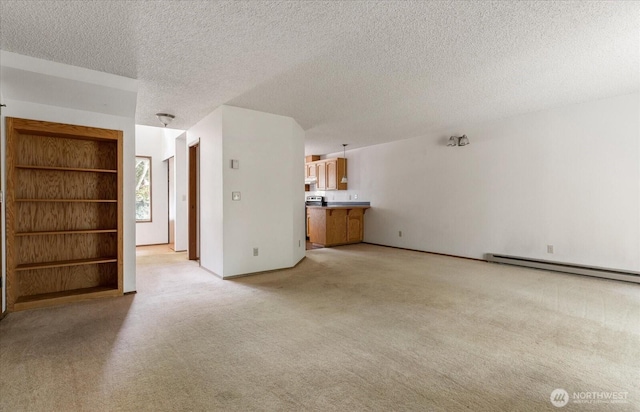 1282 Lanyard Loop Unit 1, Oak Harbor, WA 98277 - unfurnished living room featuring a baseboard radiator, light colored carpet, and a textured ceiling