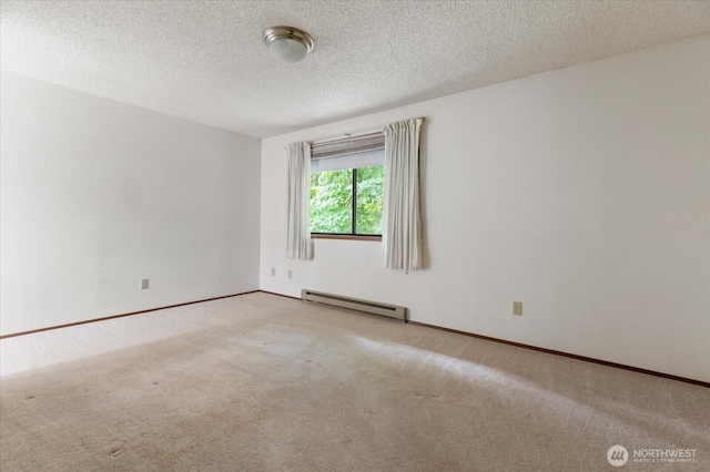 1282 Lanyard Loop Unit 1, Oak Harbor, WA 98277 - carpeted spare room featuring a baseboard radiator and a textured ceiling