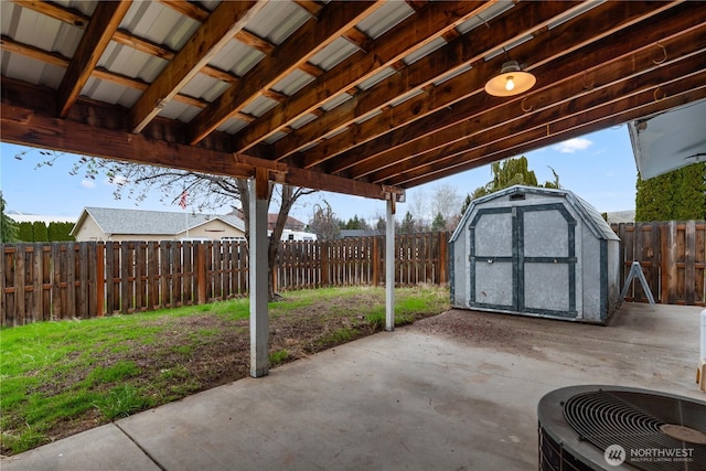 312 N Perry Ave, East Wenatchee, WA 98802 - view of patio / terrace with a fenced backyard, a shed, an outbuilding, and central AC